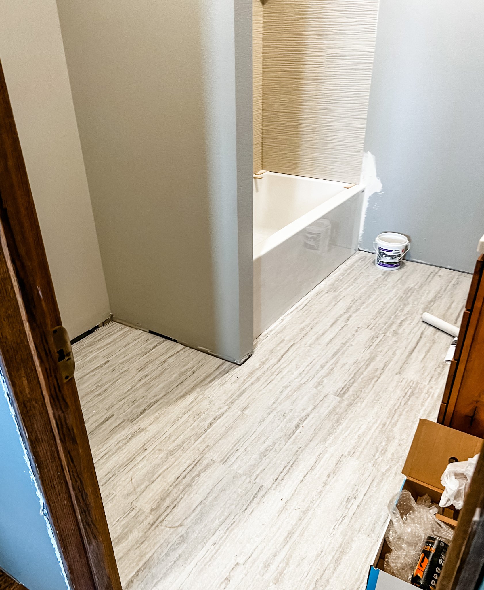 Kitchen with LVP flooring and white cabinets